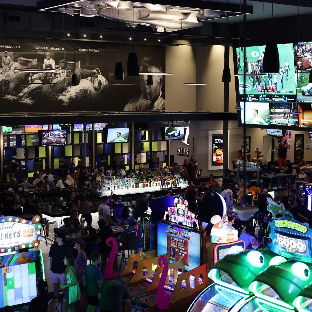 Andretti Chandler entertainment floor with bar, arcade games and video wall screens