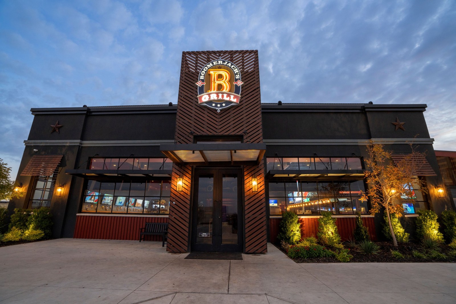 BoomerJack's Grill exterior at dusk with illuminated sign and lit entrance