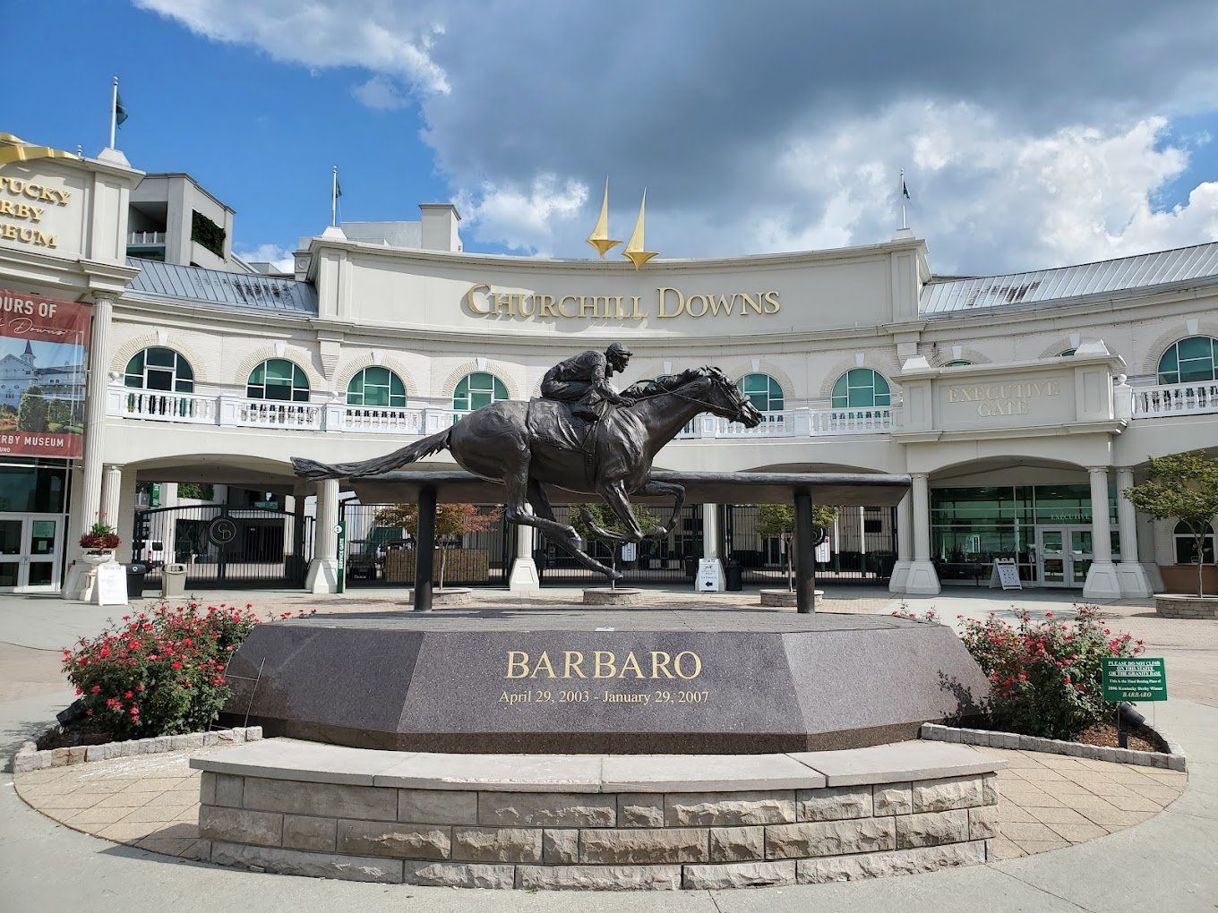 Churchill Downs entrance with the Barbaro statue in front of the gold-lettered facade