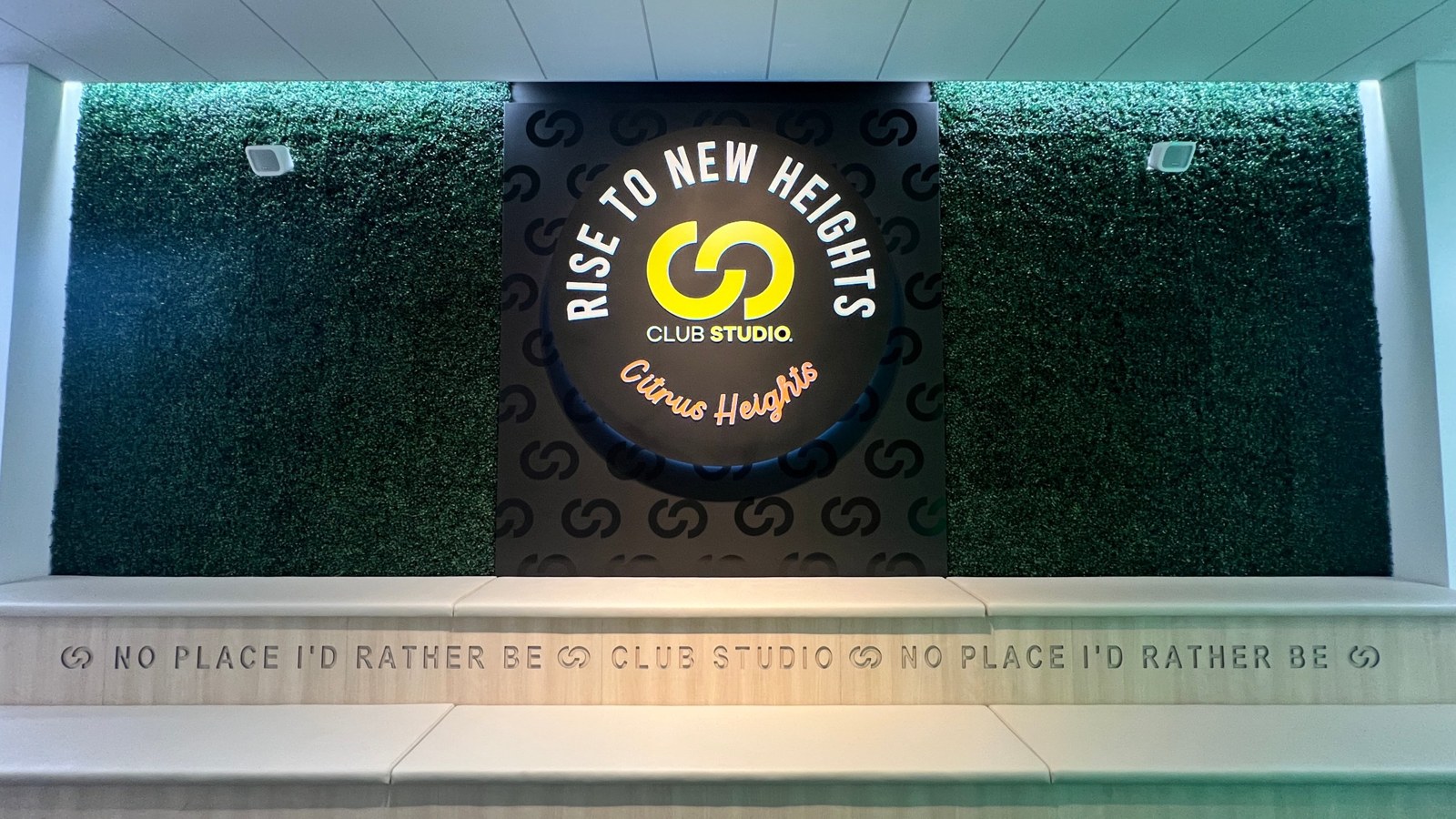 Club Studio Citrus Heights entrance sign with green wall and bench seating