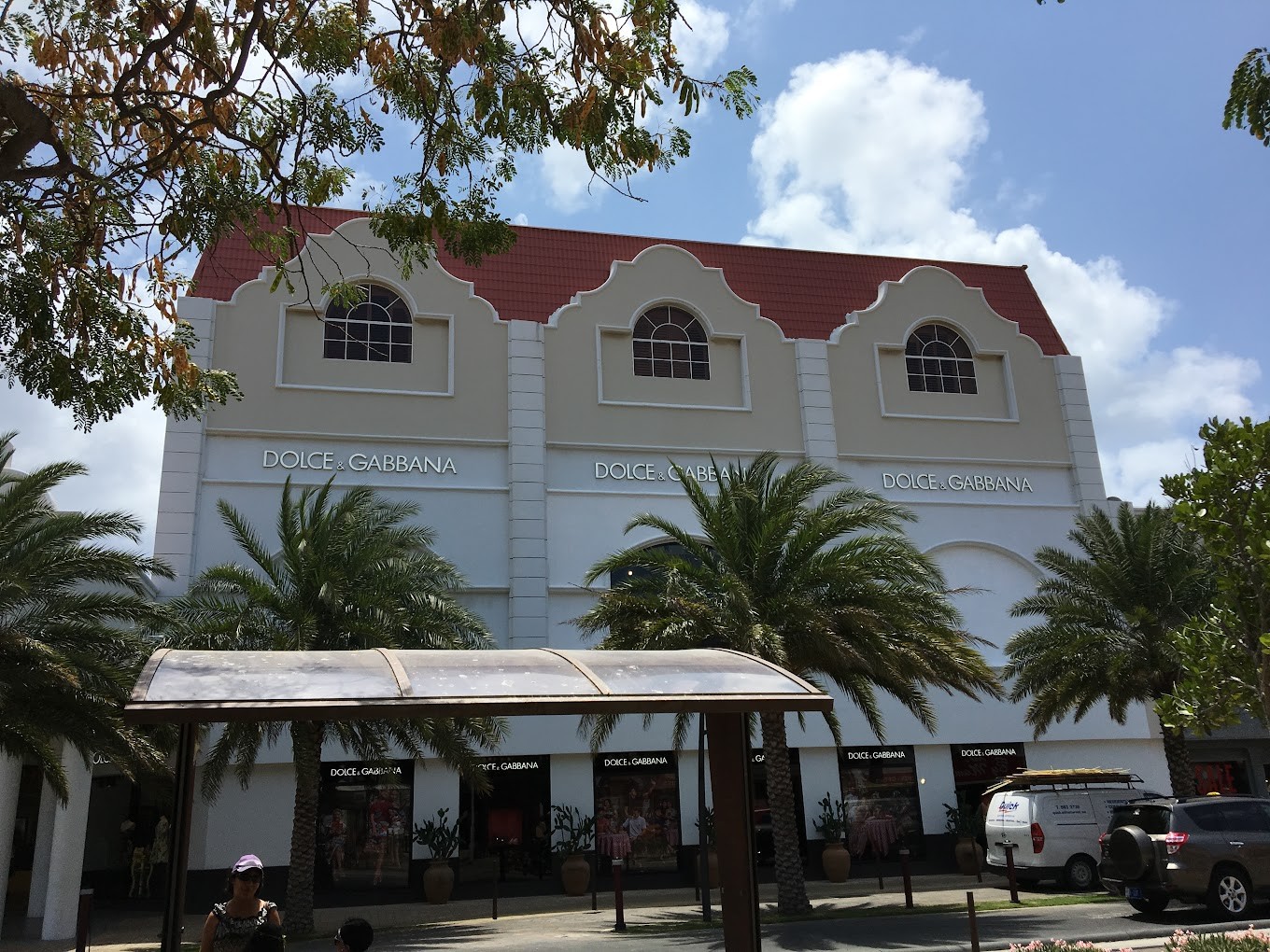 Dolce & Gabbana storefront building with palm trees in Oranjestad, Aruba