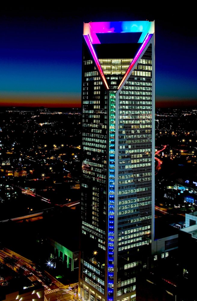 Duke Energy Tower in Charlotte at dusk with color-changing LED lighting on its crown and edge
