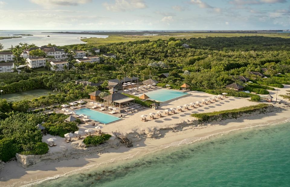 Aerial view of Parrot Cay resort pools, beach and shoreline