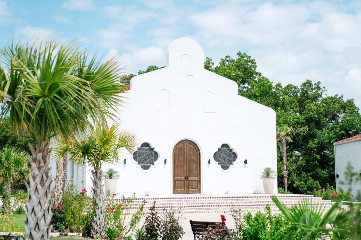 Chapel entrance with arched wooden doors and tiled steps