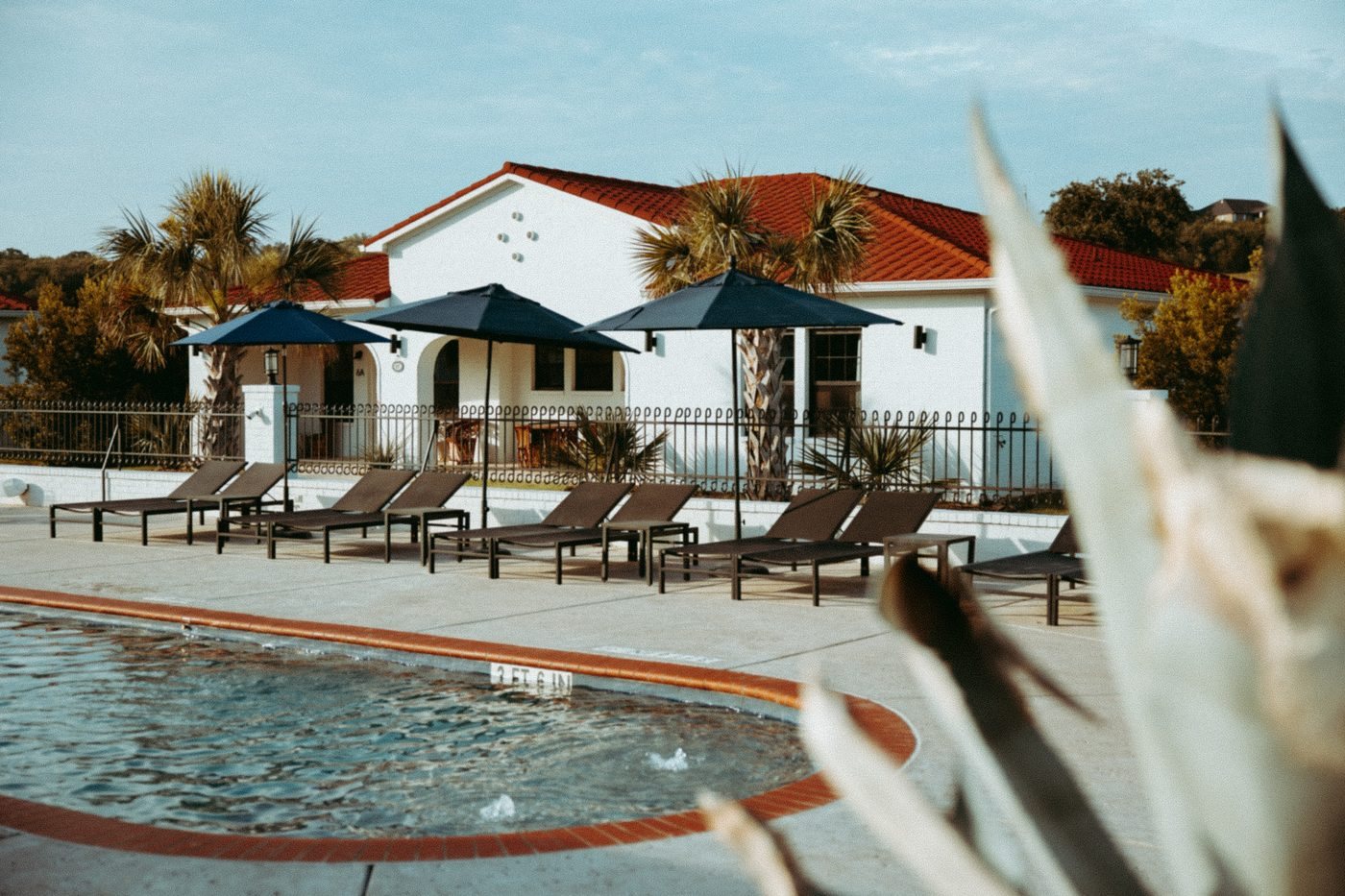 Pool deck with lounge chairs and umbrellas