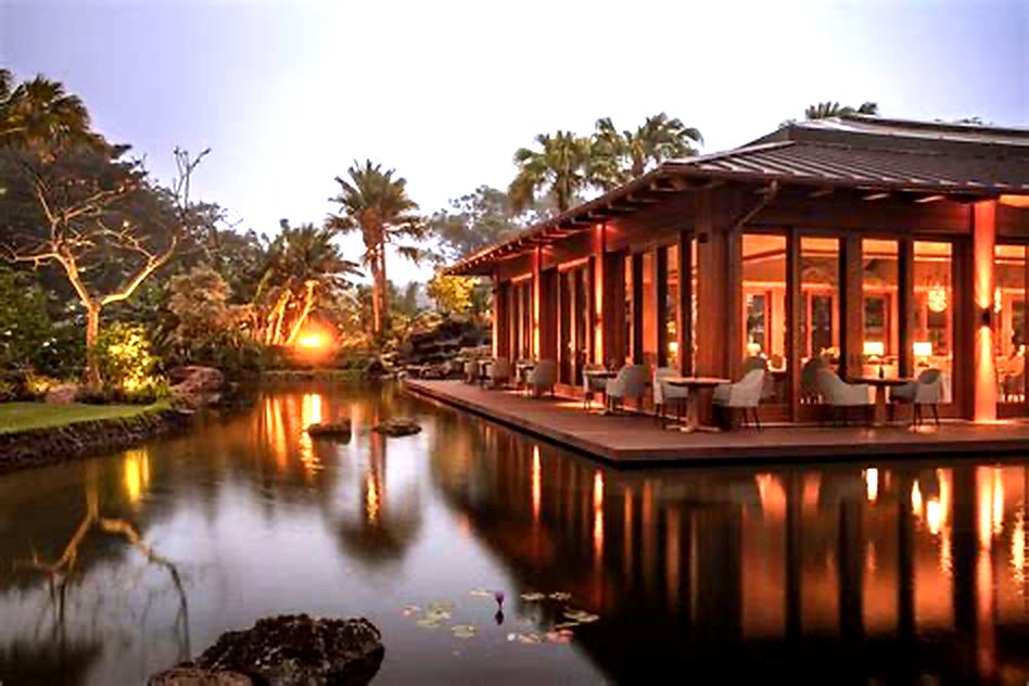 Lakeside hospitality venue at dusk with warm lighting reflected in the water