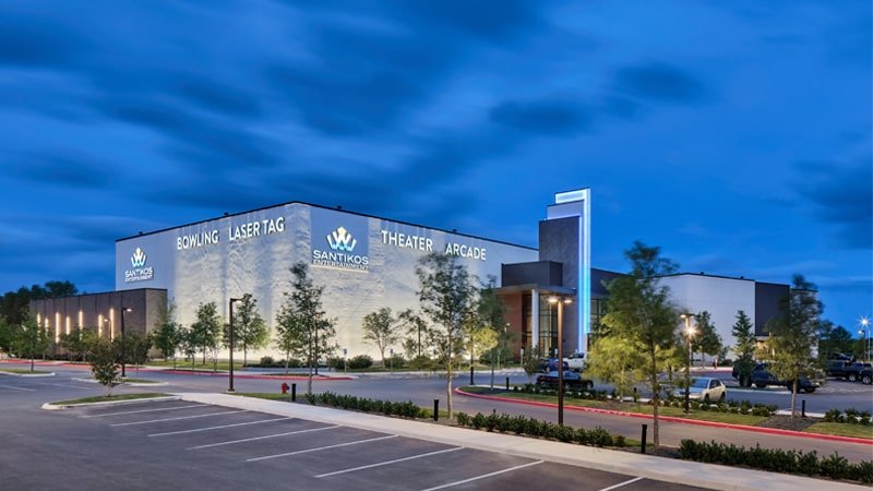 Santikos Entertainment Cibolo building at dusk with Bowling, Laser Tag, Theater and Arcade signage