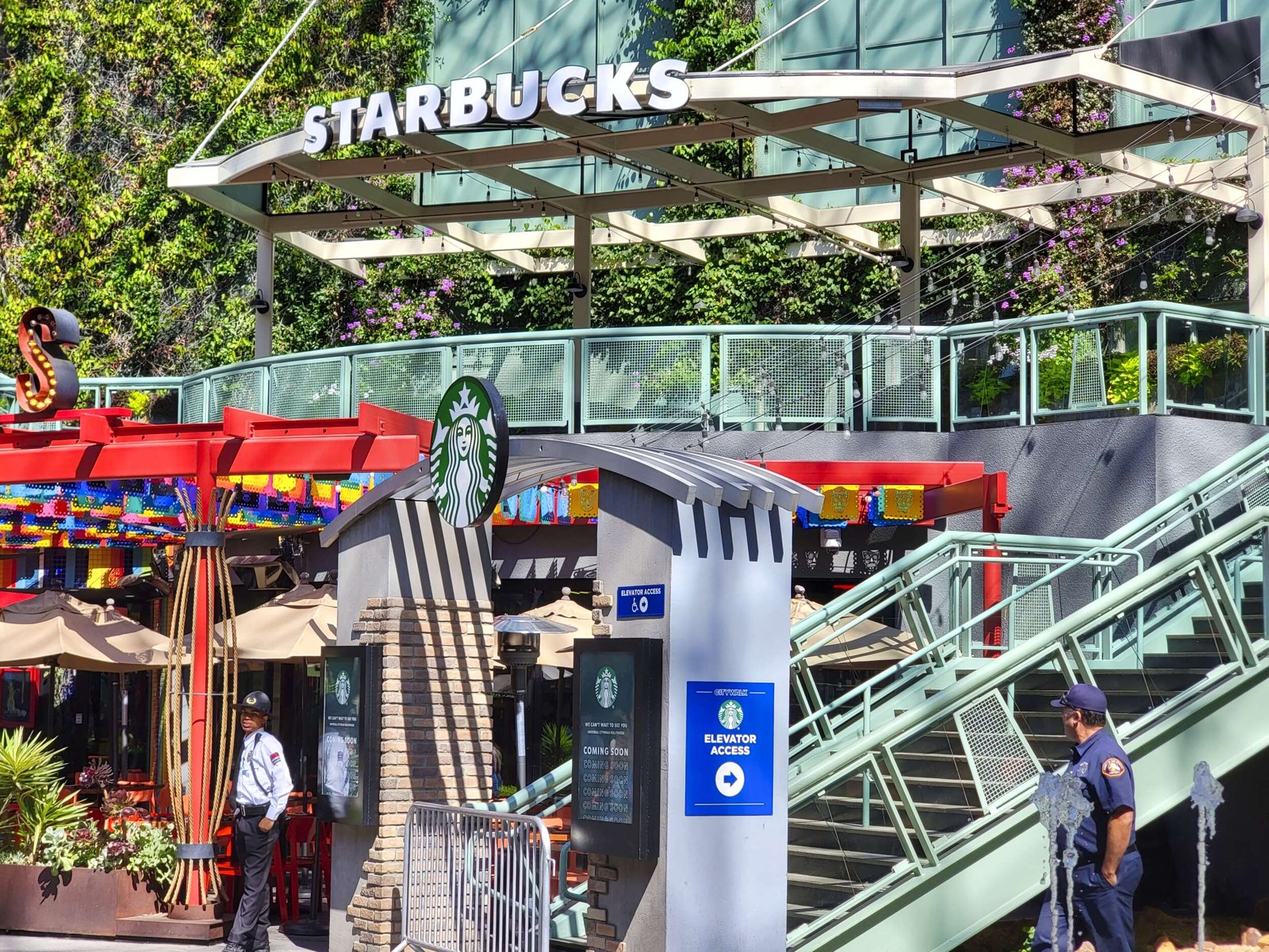 Starbucks entrance at Universal CityWalk with sign, green walls and colorful patio